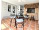 Charming dining area with tile flooring, complemented by a glass table and seating with a tiki bar at 415 Oakwood Blvd, Sarasota, FL 34237