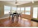 Dining area with windows overlooking water, tile flooring, complemented by a glass table and seating at 415 Oakwood W Blvd, Sarasota, FL 34237