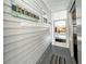 Side entrance with gray vinyl siding and decor, leading to a screened porch at 415 Oakwood W Blvd, Sarasota, FL 34237
