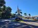 Community entrance featuring an American flag and palm trees, creating an inviting atmosphere for residents at 415 Oakwood Blvd, Sarasota, FL 34237