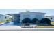 Charming single-story home featuring a covered parking area, lovely landscaping, and a welcoming facade at 415 Oakwood W Blvd, Sarasota, FL 34237