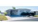 Charming single-story home featuring a covered parking area, lovely landscaping, and a welcoming facade at 415 Oakwood W Blvd, Sarasota, FL 34237