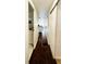 Hallway with dark wood floors connecting bathroom, kitchen, and living areas at 415 Oakwood W Blvd, Sarasota, FL 34237