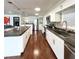 Open kitchen with white cabinetry, dark countertops, stainless appliances, and a seamless flow to the living area at 415 Oakwood Blvd, Sarasota, FL 34237