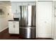 Kitchen features stainless steel refrigerator, white cabinetry, and dark countertops at 415 Oakwood W Blvd, Sarasota, FL 34237