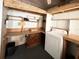 Laundry room with washer, shelving, and wooden countertops for folding laundry at 415 Oakwood W Blvd, Sarasota, FL 34237