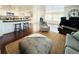 Bright living room featuring an open floor plan, dark hardwood floors, and a modern kitchen with a breakfast bar at 415 Oakwood W Blvd, Sarasota, FL 34237