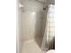 Tiled shower stall features a showerhead and convenient shelving, enclosed with a curtain at 415 Oakwood W Blvd, Sarasota, FL 34237