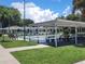 Covered shuffleboard courts featuring multiple lanes, benches, and shade trees offer an inviting recreational space at 415 Oakwood W Blvd, Sarasota, FL 34237