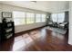 Cozy sunroom with hardwood floors, natural lighting, and charming wicker chairs, creating a relaxing retreat at 415 Oakwood W Blvd, Sarasota, FL 34237