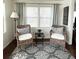 Cozy sunroom featuring wicker chairs, a side table, and soft natural lighting for a relaxing and inviting atmosphere at 415 Oakwood W Blvd, Sarasota, FL 34237