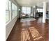 Sunroom with hardwood floors, bright windows, wicker chairs, and seamless transition into the adjacent living area at 415 Oakwood W Blvd, Sarasota, FL 34237