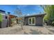Inviting backyard with pergola, picnic table, and a charming landscape featuring gravel and lush bamboo at 4857 Stevens Dr, Sarasota, FL 34234