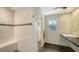 Bright bathroom featuring a walk-in shower with white tiling and a modern floating sink at 4857 Stevens Dr, Sarasota, FL 34234