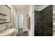 Contemporary bathroom with sleek black tiled shower and unique green mosaic-tiled vanity at 4857 Stevens Dr, Sarasota, FL 34234