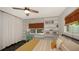 Bright bedroom with built-in bookshelves, desk, ceiling fan and yellow bedding at 4857 Stevens Dr, Sarasota, FL 34234