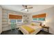 Stylish bedroom with built-in bookshelves, a ceiling fan, and natural light from the windows at 4857 Stevens Dr, Sarasota, FL 34234