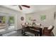 Inviting dining area with a wooden table, wicker chairs, and views of the outdoor kitchen at 4857 Stevens Dr, Sarasota, FL 34234