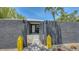 Eye-catching home with textured gray walls, yellow decor, and an inviting open gate to the front entrance at 4857 Stevens Dr, Sarasota, FL 34234
