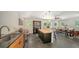 Open kitchen flows into dining area with island seating and stylish design elements at 4857 Stevens Dr, Sarasota, FL 34234