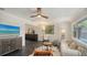 Bright living room featuring dark tile floors, a modern ceiling fan, and contemporary furnishings at 4857 Stevens Dr, Sarasota, FL 34234