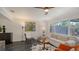 Well-lit living room with dark tile floors, a modern ceiling fan, and a comfortable seating arrangement at 4857 Stevens Dr, Sarasota, FL 34234