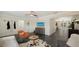 Spacious living room with dark tile floors, contemporary decor, and an open layout to the dining area at 4857 Stevens Dr, Sarasota, FL 34234