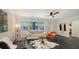 Inviting living room featuring a modern ceiling fan, stylish decor, and comfortable seating at 4857 Stevens Dr, Sarasota, FL 34234