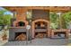 Outdoor kitchen area with brick pizza oven and grill, perfect for entertaining at 4857 Stevens Dr, Sarasota, FL 34234