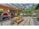 Outdoor kitchen featuring a brick pizza oven and pergola, creating an ideal setting for entertaining guests at 4857 Stevens Dr, Sarasota, FL 34234