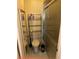 Bathroom featuring tiled floors, a toilet, storage shelving, and a glass-door shower at 5014 Barrington Cir # 2102, Sarasota, FL 34234