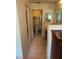Compact bathroom with tiled floors, vanity, mirror, and a glass-enclosed shower at 5014 Barrington Cir # 2102, Sarasota, FL 34234