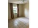 This bedroom features tile floors, a ceiling fan and natural light from the window at 5014 Barrington Cir # 2102, Sarasota, FL 34234