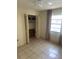 This bedroom closet features bi-fold doors, shelving, and tile floor at 5014 Barrington Cir # 2102, Sarasota, FL 34234