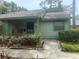 Charming home exterior featuring inviting porch and lush landscaping at 5014 Barrington Cir # 2102, Sarasota, FL 34234