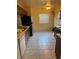 Spacious kitchen featuring tile floors, a window, and standard appliances with ample cabinet space at 5014 Barrington Cir # 2102, Sarasota, FL 34234