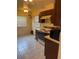 Efficient kitchen area with tile flooring, a range, and a microwave; ample sunlight through windows at 5014 Barrington Cir # 2102, Sarasota, FL 34234