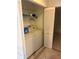 This laundry room has a washer and dryer, shelving and tile floor at 5014 Barrington Cir # 2102, Sarasota, FL 34234
