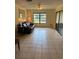 Bright living room with tile flooring, ceiling fan, and sliding glass doors to the outdoors at 5014 Barrington Cir # 2102, Sarasota, FL 34234