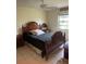 Cozy main bedroom with neutral walls, tile flooring, ceiling fan, and a dark bed set at 5014 Barrington Cir # 2102, Sarasota, FL 34234