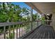 Balcony view overlooking lush greenery and a white pergola, providing a serene outdoor experience at 508 Howard Ct, Sarasota, FL 34236