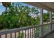 Balcony view overlooking lush greenery and a white pergola, providing a serene outdoor experience at 508 Howard Ct, Sarasota, FL 34236