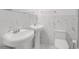 Bathroom featuring double sinks with marble-like tile at 508 Howard Ct, Sarasota, FL 34236