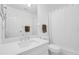 Well-lit bathroom featuring a single sink vanity, toilet, and shower with a curtain and brown towels at 508 Howard Ct, Sarasota, FL 34236
