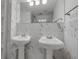 Bright bathroom with double sinks, large mirror, tiled walls, and a view of a modern, tiled shower at 508 Howard Ct, Sarasota, FL 34236