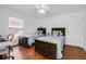 Bright bedroom with hardwood floors, two twin beds, a ceiling fan, and a window with blinds at 508 Howard Ct, Sarasota, FL 34236