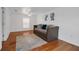 Spacious bedroom featuring a large daybed, ceiling fan, window with blinds, and wood flooring at 508 Howard Ct, Sarasota, FL 34236