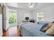 Bright bedroom with hardwood floors, two twin beds, a desk, and access to a covered porch at 508 Howard Ct, Sarasota, FL 34236