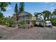 Charming two-story home with a covered parking area and a white picket fence surrounding well-maintained landscaping at 508 Howard Ct, Sarasota, FL 34236