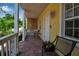 Attractive front porch with brick flooring, white railings, and a welcoming entrance at 508 Howard Ct, Sarasota, FL 34236
